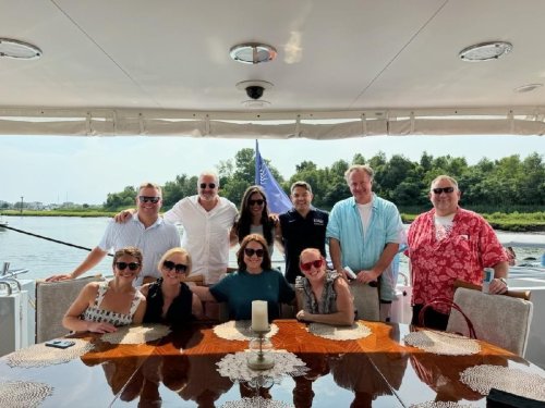 The Coons family and friends smiling on the cruise trip they won at the Geno For The Kids Charity Dinner 2024.